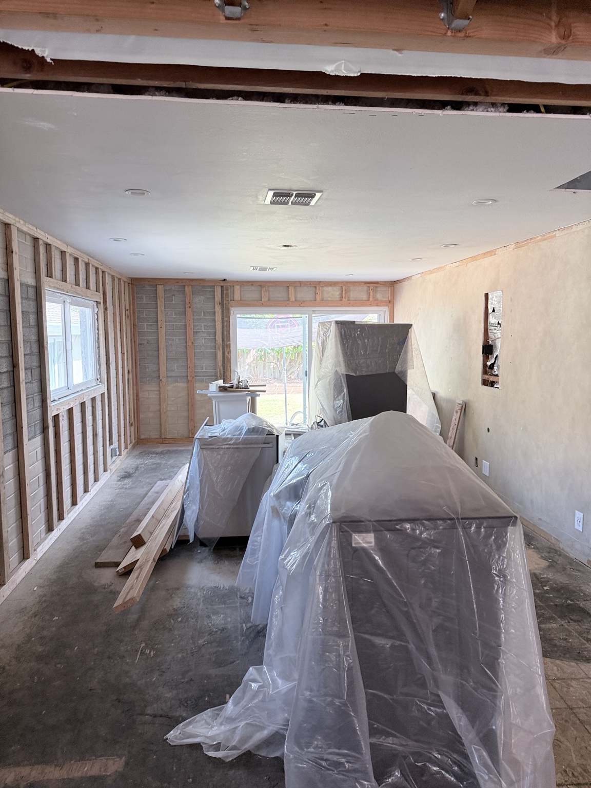 Kitchen remodel with protected cabinets and completed smooth ceiling